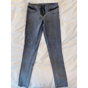 Grey jeans with black leather and tie up front